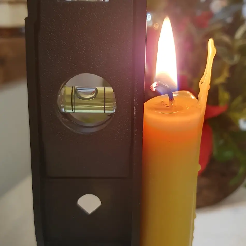 Checking Beeswax Dinner Candle is Level